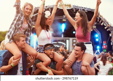 Friends having fun in the crowd at a music festival - Powered by Shutterstock