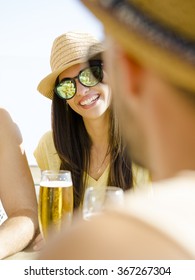 Friends Having Fun And Drinking A Cold Beer At The Beach Bar