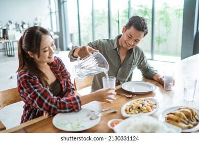 Friends Having Fun Eating Lunch Together At Home With Traditional Food