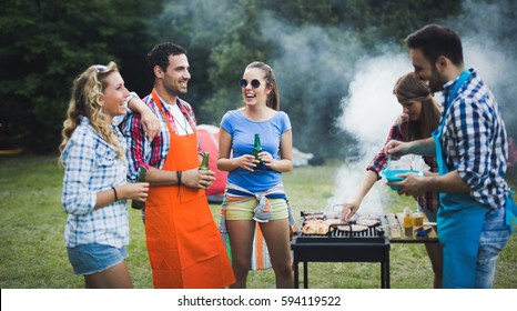 Friends having fun grilling meat enjoying bbq party