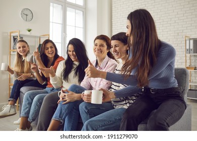 Friends Having Fun At Home. Bunch Of Ladies Enjoying Good Time And Cup Of Tea Together. Group Of Happy Young Women Sitting On Sofa, Drinking Coffee, Chatting, Laughing And Making Plans For The Weekend