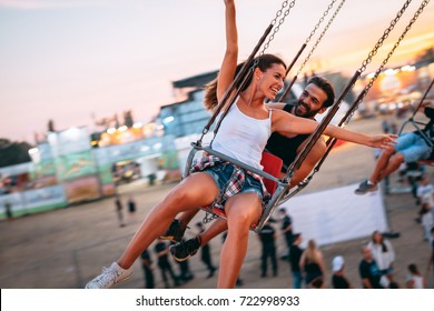 Friends Having Fun Outdoors. Amusement Park. Sunset. Soft Focus, High ISO, Grainy Image.