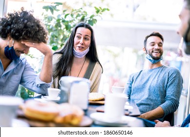 Friends having fun talking at coffeeshop - Young milenial people socializing together at restaurant cafeteria - New normal lifestyle concept with happy guys and girls at cafe bar - Bright azure filter