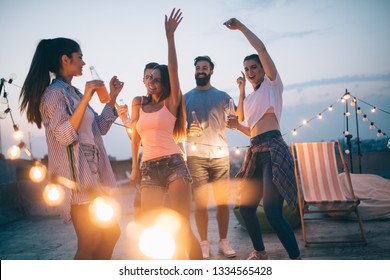 Friends Having Party On Top Of The Roof. Fun, Summer, City Lifestyle And Friendship Concept