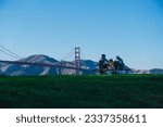 friends having a picnic in front of the golden gate in a park