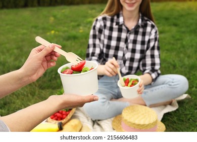 Friends Having Picnic On Green Grass In Park, Closeup