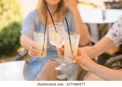 Friends having refreshing lemonade drinks on outdoors terrace. Summer lifestyle. - Powered by Shutterstock