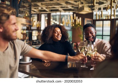 Friends Having Reunion In Wine Bar