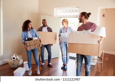 Friends Help Couple To Carry Boxes Into New Home On Moving Day - Powered by Shutterstock