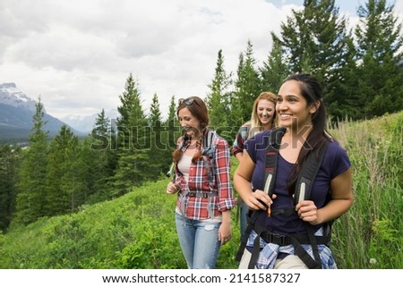 Friends hiking on trail near mountains