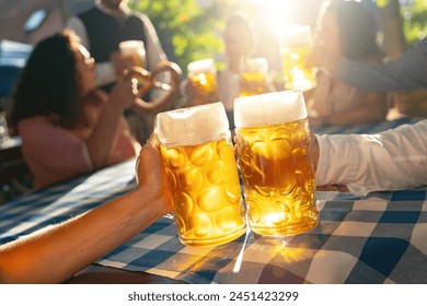 Friends holding bavarian beer mugs Toasting at a sunny day in a  - Powered by Shutterstock