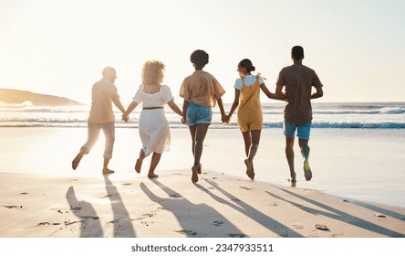 Friends, holding hands and running at sunset on beach in summer, vacation or walking together on holiday break with freedom. Group, silhouette and people with connection and support in community - Powered by Shutterstock