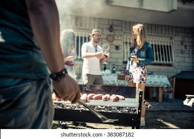 Friends In Home Garden Grilling Meat And Having Fun - Group Of People At Barbecue Party Drinking Wine