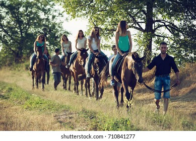 Friends Horseback Riding in the Countryside - Powered by Shutterstock