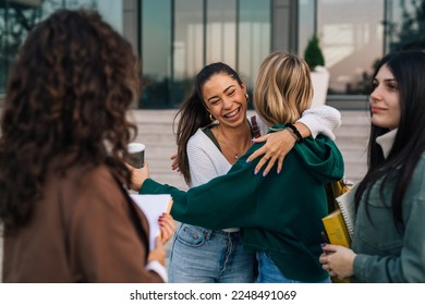 Friends hug to greet each other - Shutterstock ID 2248491069