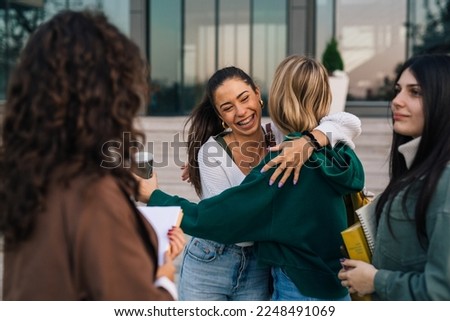 Friends hug to greet each other
