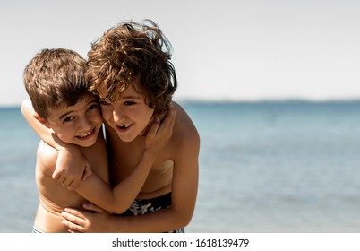 Friends hugging on the beach with the ocean floor. concept of friendship - Shutterstock ID 1618139479