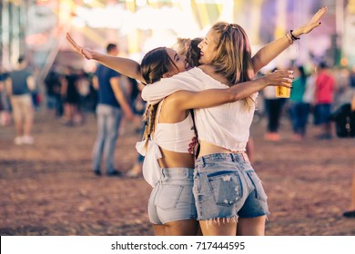 Friends Hugging On Music Festival 