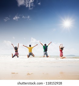 Friends Jumping On Beach