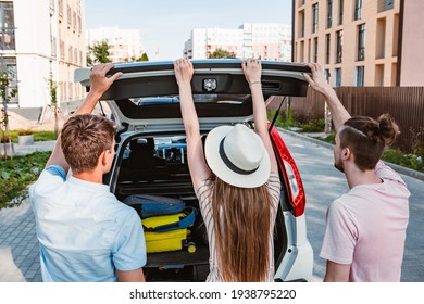 Friends Load Car Trunk With Baggage. Summer Road Trip Vacation.