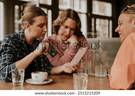 Friends looking at the bill