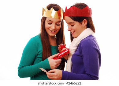 Friends Looking At Joke From Christmas Cracker On White Background