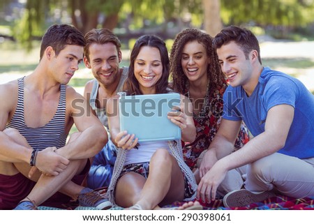 Similar – Young happy people looking tablet over table