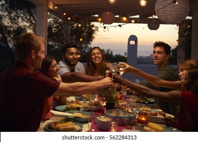 Friends Make A Toast At A Dinner Party On A Patio, Close Up