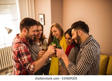 Friends Making A Beer Toast At A Home Party.