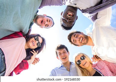 Friends Making Circle And Looking Down At Camera