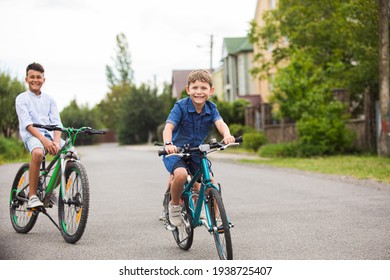 The friends on bicycles greet each other on the street