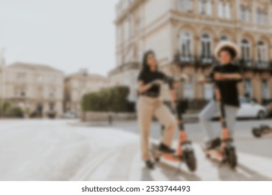 Friends on electric scooters, city sightseeing eco-friendly style. Diverse women standing on the electric scooters, ready for city sightseeing on the street. Friends on electric scooters in city - Powered by Shutterstock