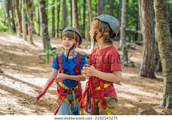 Friends on the ropes course. Young people in safety
equipment are obstacles on the road rope Portrait of a disgruntled
girl sitting at a cafe
table