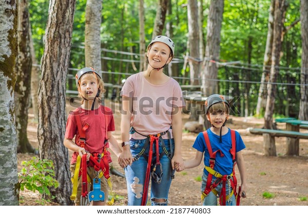 Friends on the ropes course. Young people in safety
equipment are obstacles on the road rope Portrait of a disgruntled
girl sitting at a cafe
table