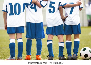 Friends On A Soccer Team Standing United In A Line. Boys In School Sports Team. Teamwork In Youth Sports Team. Children In Soccer Jersey Uniforms And Turf Cleats