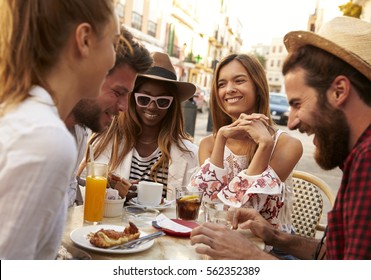 Friends On Vacation Having Fun Outside A Cafe In Ibiza, Close Up