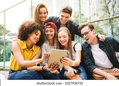 Friends in the park using a digital tablet millennial and youth culture concept - Powered by Shutterstock