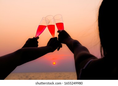 Friends Party Drinks Toast Celebration On Yacht At Twilight, Happy Friends Having Party Celebrating And Drinking At The Beach On Vacation In Summer Twilight Sunset.
