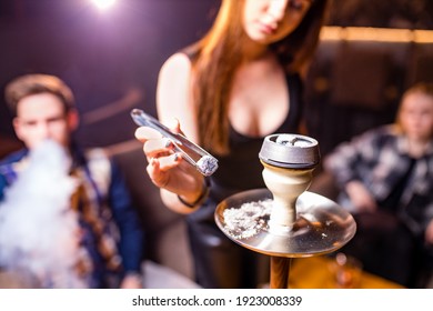 Friends party in hookah lounge smoking shisha night time
