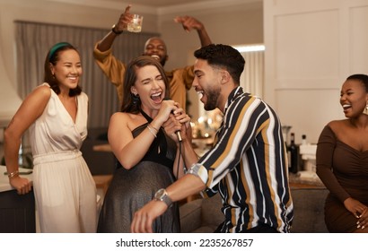 Friends, party and karaoke night at the house for fun social event or gathering together in celebration for new year. Happy people celebrating friendship, birthday or festive season singing at home