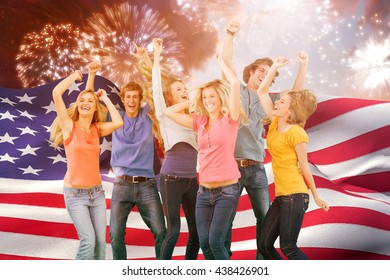 Friends partying together while laughing and smiling against colourful fireworks exploding on black background - Powered by Shutterstock