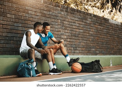 Friends, phone and break after exercise, workout and basketball game in city with men bonding and laughing. Sports, rest and two guys having fun, enjoying social media comedy, post and online meme