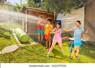 Friends Play Water Gun Fight In The Garden