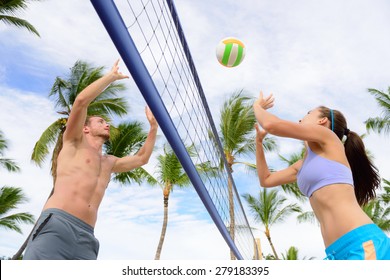 Friends Playing Beach Volleyball Sport. Woman And Man Having Fun Recreational Volley Ball Game In Summer Living Healthy Active Sport Lifestyle.