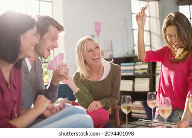 Friends playing card games in living room - Powered by Shutterstock