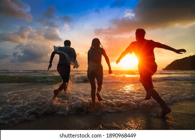 Friends playing on beach, Ko Kut Thailand