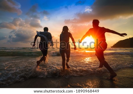 Friends playing on beach, Ko Kut Thailand