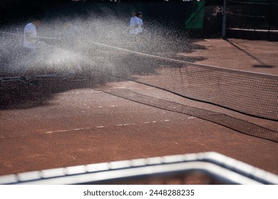 friends playing tennis on a clay court, sweeping, watering and bagging a clay court. doing tennis court maintenance in australia - Powered by Shutterstock