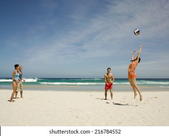 Friends playing volleyball on the beach. - Powered by Shutterstock