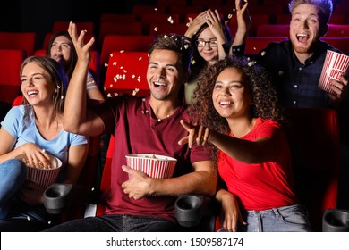 Friends With Popcorn Watching Movie In Cinema